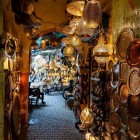 Shopping in the Medina of Marrakech through the narrow souk streets for local handcrafted copper and wrought iron items