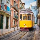 Typical Portuguese vintage trams in the historic Alfama district of Lisbon