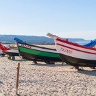 Typical Portuguese fishing boats on the beach in Nazaré