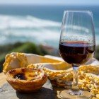 Glass of Porto wine and Pastel de nata, a typical Portuguese egg custard tart