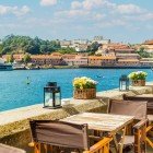 View of an outdoor café on the banks of the Douro River in Porto, Portugal