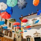 Évora, a typical city square covered with floating colorful umbrellas