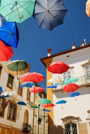 Évora, a typical city square covered with floating colorful umbrellas