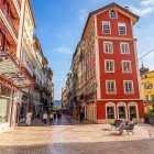 The beautiful cobbled streets of downtown Coimbra, dating back to the medieval era, with the typical houses featuring particularly narrow profiles