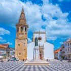 The Igreja de São João Baptista, a three-nave church with a Manueline-style portal. Located in the historic center of Tomar, Portugal, it was built in the 15th century and reconstructed in the 16th century