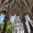 Quinta da Regaleira, also known as Palácio da Regaleira in Sintra, is a 5-hectare estate featuring a neo-Gothic mansion adorned with stone sculptures and gargoyles, along with gardens and grottoes.