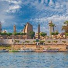 Luxor stands on the ancient site of Thebes on the east bank of the Nile in southern Egypt. Less than 1 km away is the Luxor Temple, and not far off are the tombs of the Pharaohs in the Valley of the Kings and the Valley of the Queens