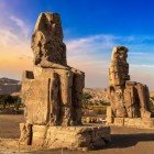 Colossi of Memnon, enormous stone statues built by Pharaoh Amenhotep III over 3400 years ago in the Theban necropolis on the opposite bank from the city of Luxor