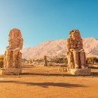 View of the Theban Necropolis on the opposite bank of the Nile from the city of Luxor, featuring the Colossi of Memnon, which were built over 3400 years ago by Pharaoh Amenhotep III