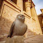 Temple of Edfu on the west bank of the Nile, between Esna and Aswan, highlighting the statue of the falcon god Horus