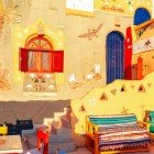 Details of a Nubian house characterized by vibrant colors seen at sunrise in a village near Abu Simbel in the Aswan Governorate of Egypt