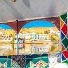 Nubian village near Aswan seen from a boat on the Nile; Nubian villages are characterized by white houses decorated with very vibrant paintings.