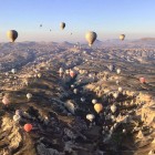 Cappadocia, a semi-arid region in central Turkey, is known for its famous "fairy chimneys," tall cone-shaped rock formations found in the Monks Valley, Göreme, and other areas