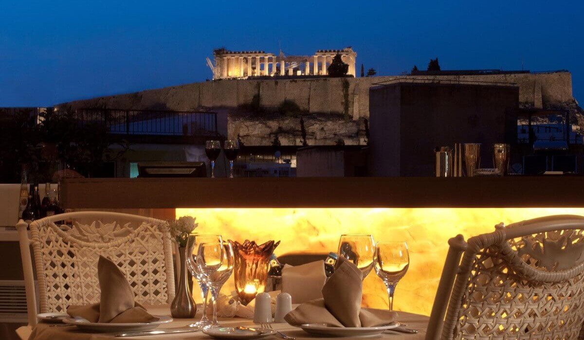 The  Athenian Callirhoe Exclusive Hotel - From the terrace, guests can admire the imposing Parthenon, which towers over the hill, beautifully illuminated at sunset