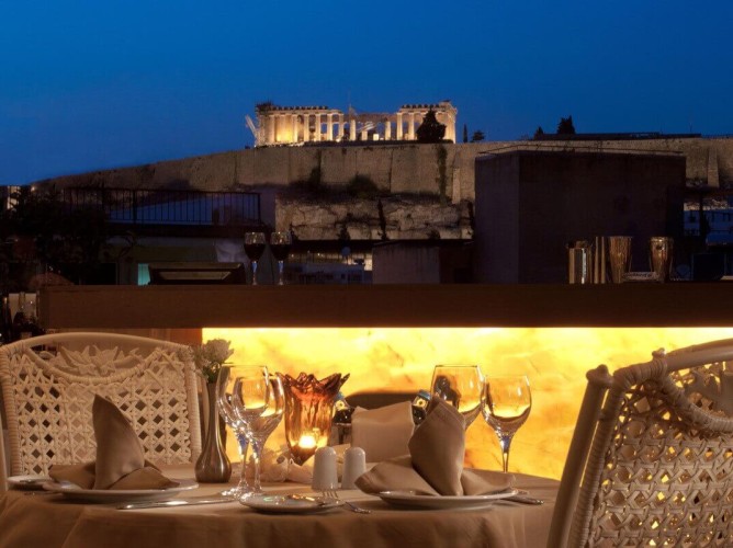 The  Athenian Callirhoe Exclusive Hotel - From the terrace, guests can admire the imposing Parthenon, which towers over the hill, beautifully illuminated at sunset